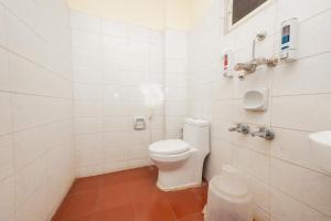 a white bathroom with a toilet and a sink at The Grand Rajmahal in Bangalore +16 photos
