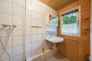 a bathroom with a sink and a shower at Bungalow 35 - Kimbucht in Reichendorf +19 photos