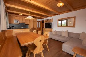 a kitchen and living room with a table and a couch at Duxeranger C Top 8 in Krimml