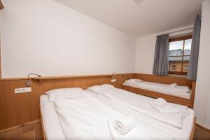 a bedroom with two beds and a window at Duxeranger C Top 8 in Krimml