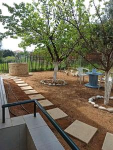 a park with two trees and a bench at Dimitra's Apartment in Petalidhion