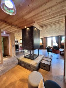a living room with a large fireplace in a house at Chalet Virolet in Les Gets