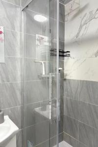 a shower with a glass door in a bathroom at Seaside Haven Retreat in South Shields in South Shields