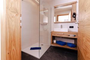 a bathroom with a shower and a sink at Gasthof Aigner *** in Fügen +58 photos