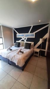 a bedroom with a large bed in a room at Luxury Beachfront Penthouse Umdloti in Umdloti