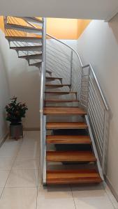 a metal staircase with wooden steps in a room at Luxury Beachfront Penthouse Umdloti in Umdloti