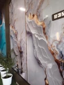 a wall with a painting of a river at Hotel Nehal in New Delhi