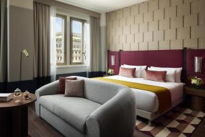 a hotel room with a bed and a couch at Tivoli President Milano Hotel in Milan