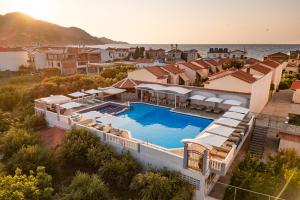 an aerial view of a house with a swimming pool at Hotel Athena in Kokkari