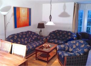 ein Wohnzimmer mit zwei Sofas und einem Tisch in der Unterkunft Ferienhaus Berta in Süderende