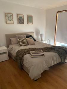 a bedroom with a large bed with two towels on it at Happy Valley Haven in Sunset Strip