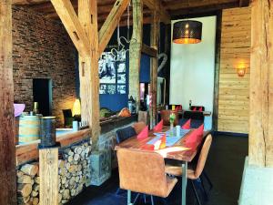 a dining room with a wooden table and chairs at Hofschänke in Winden