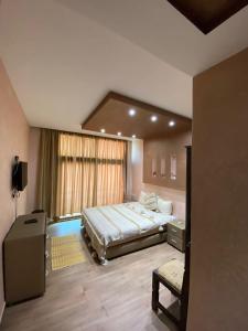 a bedroom with a large bed and a window at Nomad Surf Hotel in Tamraght Ouzdar