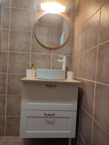 a bathroom with a sink and a mirror at Gîte romantique avec bain à remous privatif près de Sarlat in Saint-Cyprien