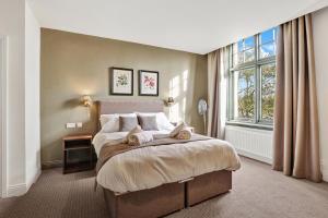 a bedroom with a bed and a large window at The Lambton in Durham +16 photos