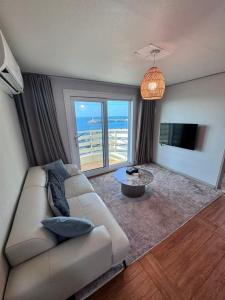 a living room with a couch and a view of the ocean at Hong Yang in Jeju