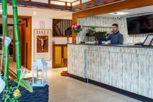 a man standing at a bar in a restaurant at Checkin Travé in Figueres +23 photos