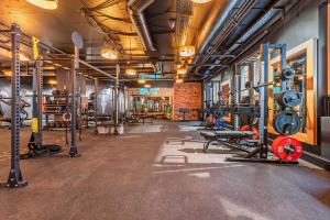 a gym with lots of equipment in a room at ART HOUSE Basel - Member of Design Hotels in Basel