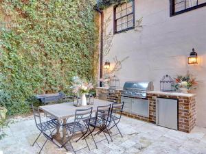 a patio with a table and chairs and a stove at Elsewhere on Madison Square Main in Savannah
