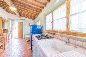 a kitchen with a sink and a stove at Agriturismo Il poggiarello in Foiano della Chiana +101 photos