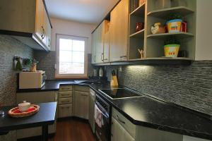 a kitchen with a sink and a counter top at Domek Markoušovice in Velké Svatoňovice
