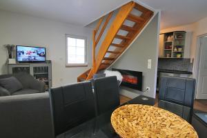 a living room with a couch and a fireplace at Domek Markoušovice in Velké Svatoňovice