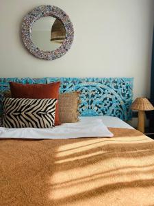 a bedroom with a bed with a mirror on the wall at City Solei Boutique Hotel in Poznań