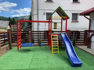 a playground with a slide and a slideintend at Pensiunea Curcubeu in Buşteni
