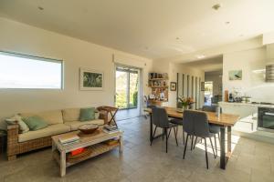 un soggiorno con un divano e un tavolo di Villa Lucy by PosarelliVillas a Plataniás