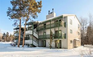 an apartment building in the snow with trees at RMR: Spruces 6 Condo in The AspensWilsonWY in Wilson