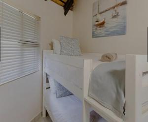 a bedroom with two bunk beds and a window at Banana Beach Club C5 in Port Shepstone +9 photos