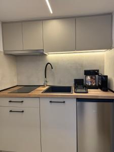 a kitchen with white cabinets and a sink at Room8 Suites in Thessaloniki +31 photos