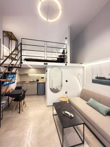 a living room with a couch and a loft at Room8 Suites in Thessaloniki