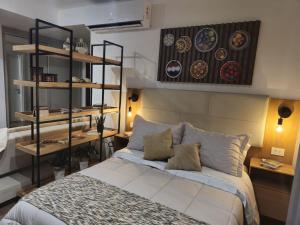 a bedroom with a bed and shelves in it at Acogedor loft a pasos de todo in Asuncion +18 photos