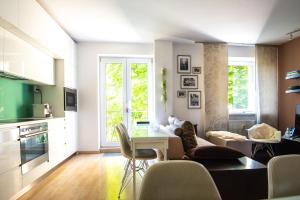 a kitchen and living room with a table and chairs at Charming 2-BR apartment at Nivy Bratislava in Nivy
