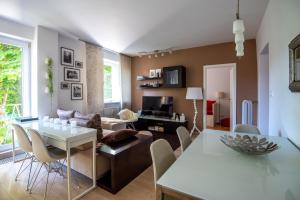 a living room with a table and a couch at Charming 2-BR apartment at Nivy Bratislava in Nivy +9 photos