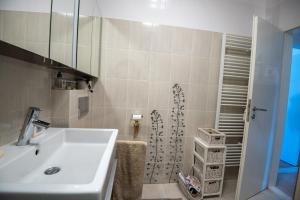 a bathroom with a sink and a shower at Charming 2-BR apartment at Nivy Bratislava in Nivy