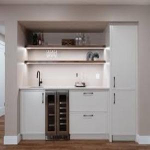 Una cocina con gabinetes blancos y un fregadero. en Stay Maison, en Rawalpindi