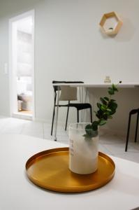 a vase on a plate with a plant in it at A&I Apartments & Studios in Athens