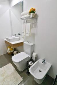 a bathroom with a white toilet and a sink at Un espacio de lujo para que te sientas en casa in Asuncion