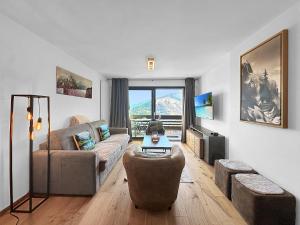 a living room with a couch and a table at Breathtaking view -Nendaz - 4 Valleys - Swiss Alps in Nendaz