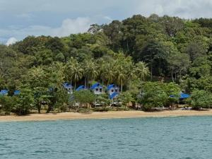 a house on the shore of a beach with trees at SeaSmile Beach Resort Koh Jum Formerly Sunsmile in Ko Jum