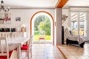 a kitchen and dining room with a white table and chairs at La Maison Du Bonheur in Fresnay-en-Retz