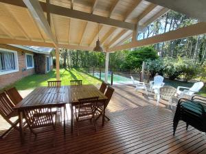 a wooden deck with a table and chairs on it at Casa grande Carilo in Carilo