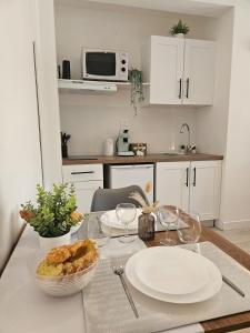 a kitchen with a table with a plate of food on it at Nature Studio Garden & Parking Grasse Hills in Grasse