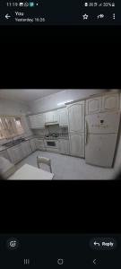 a picture of a kitchen with white cabinets at Weibdeh 3b furnished rooms in Amman