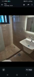 a bathroom with a sink and a mirror and a toilet at Weibdeh 3b furnished rooms in Amman