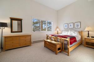 a bedroom with a bed and a dresser and a window at RMR: Mountain Maple 4 Condo in The Aspens in Wilson