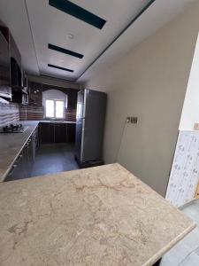 a kitchen with a counter top in a room at Jd apartment in Kariāla Railroad Station