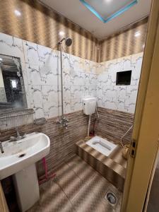 a bathroom with a sink and a toilet at Jd apartment in Kariāla Railroad Station